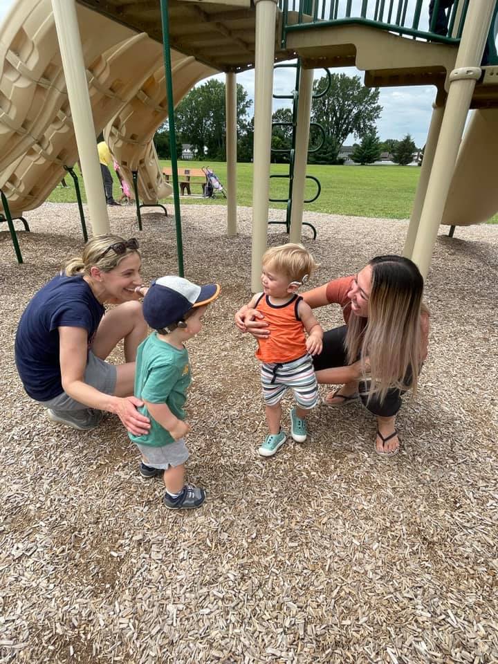 Two women with two child playing together