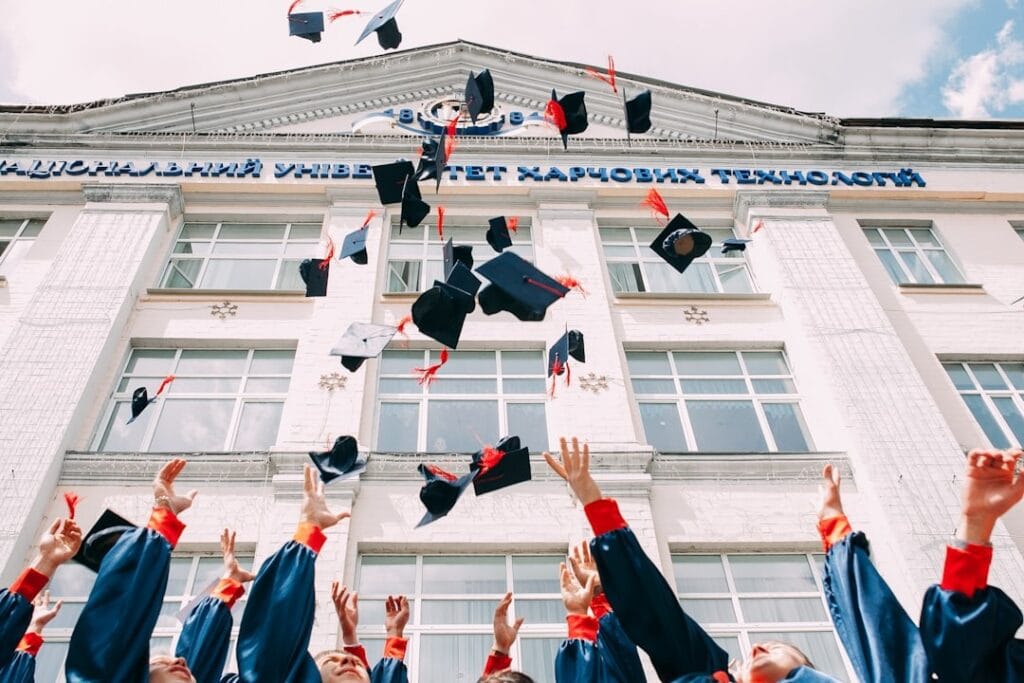Image of graduates throwing caps in air