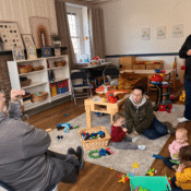 Image of people gathering while children play.