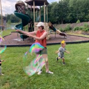 Children playing with large bubbles.