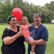 Parents with a girl holding a balloon