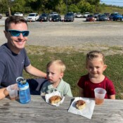 Image of family at the picnic table.