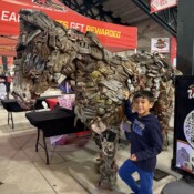 Image of boy next to statue